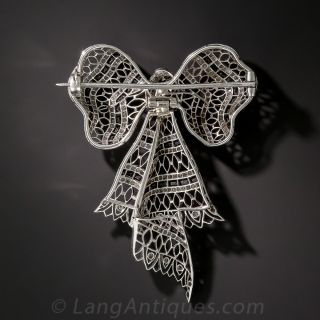 Edwardian Platinum, Diamond and Onyx Bow Knot Brooch