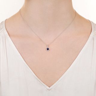 Petite.33 Carat Sapphire and Diamond Halo Pendant