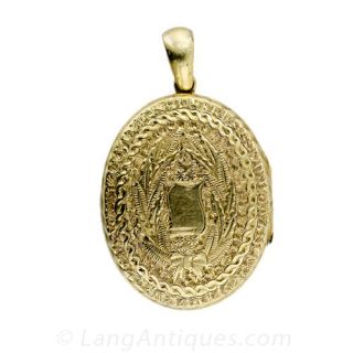 Victorian Engraved Oval Locket with Cross and Floral Motifs